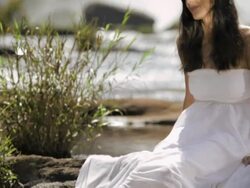Young woman sitting near waterfall at forest, Athirappilly, Kerala, India Stock Footage