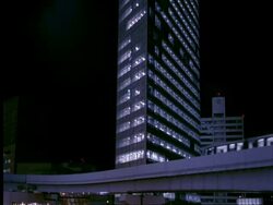WA modern shiodome buildings, Yurikamome line train moves past, Tokyo, Japan Stock Footage