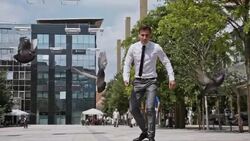 SLO MO Yuppie skateboarding through pigeons Stock Footage