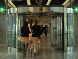SLOW MOTION People walk through revolving door at airport Stock Footage