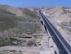 Aerial Highway 1 connecting Jerusalem and the West Bank until the Beit HaArava Junction with Route 90 south of Jericho near the shores of the Dead Sea., Northern Judea Desert Stock Footage