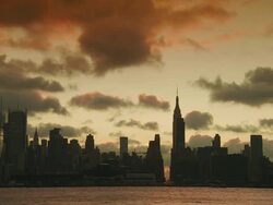 The hudson river, the empire state building, the new yorker, 34th street and the manhattan skyline as clouds move overhead at sunrise Stock Footage