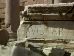 Medium pan-left - Inscribed plinths crumble around columns and other ruins. Stock Footage