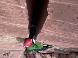 MS Looking down on climber and he ascends in very steep and wide crack / Zion,UT,USA Stock Footage