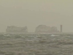 WA view shot across rough sea to distant, Needles light house, United Kingdom Stock Footage