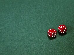 MS SLO MO Red dice rolling against green background / Vieux Pont, Normandy, France Stock Footage