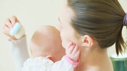 mother brushing baby Stock Footage