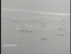 1945: MICRONESIA: NEAR CAROLINE ISLANDS: Aerial US Pacific Fleet ships of many sizes on water. General Simon B. Buckner, Jr. , Vice-Admiral Richmond K. Turner & Major-General Oliver P. Smith sitting at map table, MS Turner talking (No SOT). WWII Instructional Video