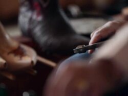 CU boot maker tacking vamp to sole of cowboy boot Stock Footage