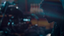 Man sitting in motorcycle workshop drinking coffe Stock Footage