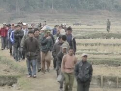 WS large crowd of people returning from field / Xam Neua, Laos Stock Footage