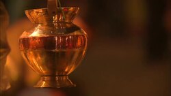 Brass urns hang from a vendor's booth at a marketplace in India. Stock Footage
