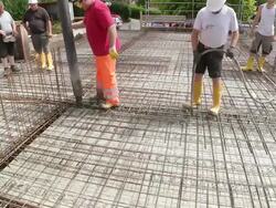 MS Shot of workmen casting concrete at house construction, building site / Hermeskeil, Rhineland Palatinate, Germany Stock Footage