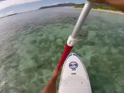 POV of a man stand-up paddle boarding in the lagoon around Bora Bora island in French Polynesia. - Slow Motion Stock Footage