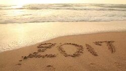 Concept: Drawing 2017 on the sand beach at end of year time Stock Footage