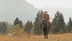 DS Female rancher riding a horse in countryside Stock Footage
