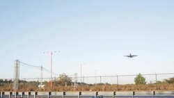 Plane Flying Passing highway and landing Stock Footage