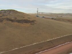 WS AERIAL  Shot of oil drilling rig at Bakken oil field in snowy fields near Watford City / Watford City, North Dakota, United States Stock Footage