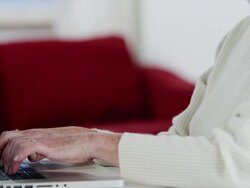 MS tilt up senior woman using laptop Stock Footage
