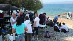 Syrian migrants fleeing the war and escaping to Europe, landing on the Greek island of Lesvos on the north coast at Efthalou and helped ashore by volunteers. Up to 4,000 migrants a day are landing on the island and overwhelming the authorities. They are tr Stock Footage
