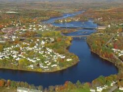 WS ARIEAL View of City with dam / Maine, United States Stock Footage