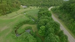Cyclist riding alone on the county road Stock Footage