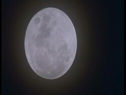 MCU Oval shaped full moon in black sky, South America Stock Footage