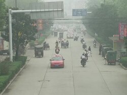 Traffic in smog along road in WuXue News Clip