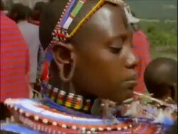 CU Decorated Masai tribeswoman performing ritual dance, Kenya Stock Footage