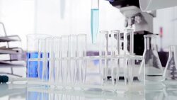 Scientist placing vial into test tube rack Stock Footage