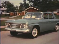 1964 Studebaker Challenger in 1960s suburb Stock Footage