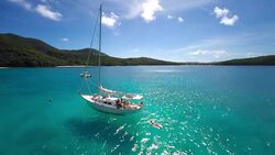 aerial video of group of people relaxing on a sailboat anchored in Hawksnest Bay, St.John, US Virgin Islands(2) Stock Footage