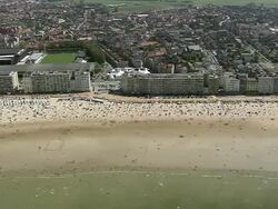 WS AERIAL PAN View of people enjoying at Ostende beach / Flanders, Belgium Stock Footage
