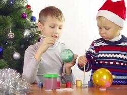 boys paints Christmas balls Stock Footage