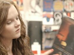 CU PAN young woman browses new vinyl records in record store / Palm Desert, California, USA Stock Footage