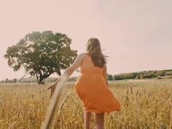 SLO MO Girl running barefoot in the grass Stock Footage