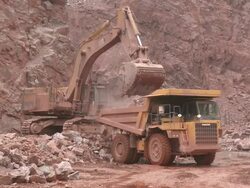 MS Excavator truck loading stone in another truck at quarry / Taben-Rodt, Rhineland-Palatinate, Germany Stock Footage
