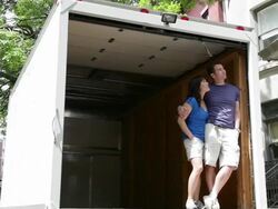 MS PAN Couple looking  out from empty moving truck / Newark, New Jersey, United States Stock Footage