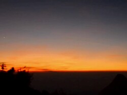 panning : two tourists at mountain peak at twilight Stock Footage