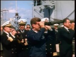 1960s John Kennedy + Naval officers on ship looking thru binoculars / newsreel Stock Footage
