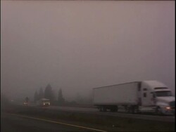 WA Traffic driving along foggy road Stock Footage