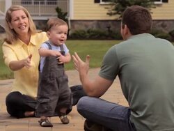 MS, Young Child Taking First Steps Between Parents, Richmond, Virginia, USA Stock Footage