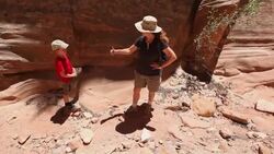 Mother gives her son a thumbs up before they begin their hike through a canyon Stock Footage