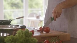 Chef cutting tomato in the kitchen Stock Footage