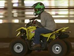Child drives ATV through the obstacle course. Stock Footage