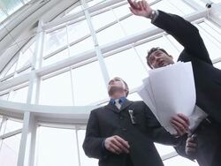  LA Business associates studying blueprints and gesturing / Seattle, Washington, United States Stock Footage