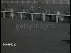 1947: POST-WAR GERMANY: HORSE RACE: Horses racing for finish line, #1 in lead, race horses running through frame. Group of people watching race, blonde woman tearing up wager ticket.  Gambling, gamblers, entertainment. Instructional Video