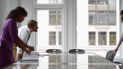 MS Businesspeople shaking hands across conference room table before sitting down for meeting Stock Footage