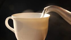 Pouring hot water in to a coffee cup Stock Footage