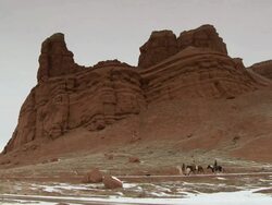 WS Three cowboys trotting on horses in front of red rock landscape / Shell, Wyoming, United States Stock Footage